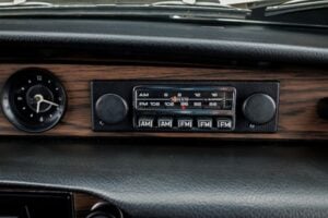 Vintage AM FM car radio representing songs remembered from the 1970s